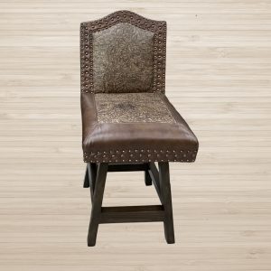 Brown leather chair with nailhead trim and a patterned fabric back, set against a light wood background.